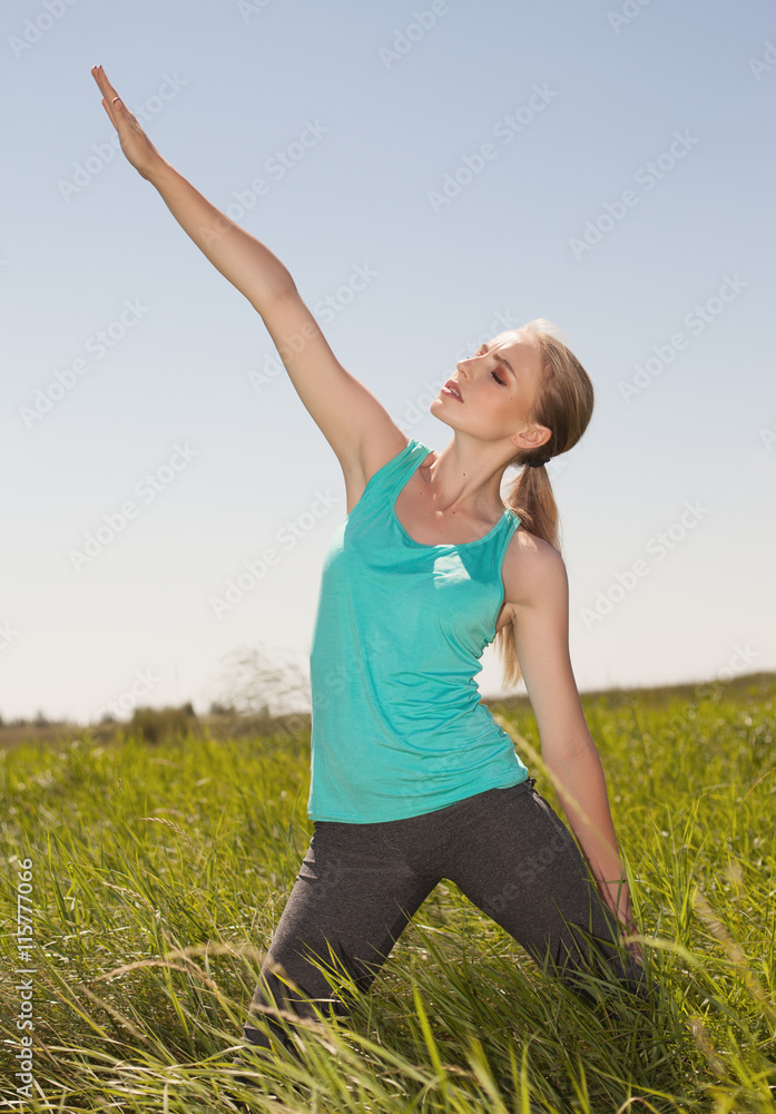Beautiful blonde woman exercising in the outdoors yoga photo