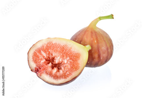 whole and half cut ripe fig with stem on white background