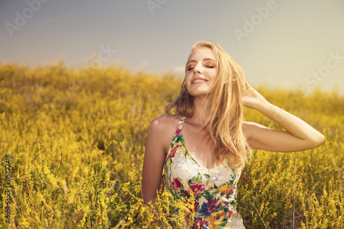 Blonde young beautiful girl in the field photo