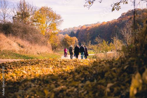 Family Walking Through autumn landscape