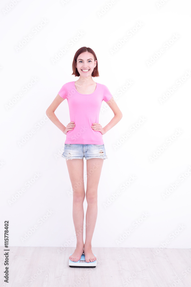 woman stands on weight machine woman stands on weight machine