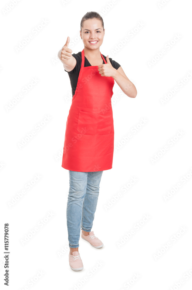 Joyful young saleswoman on supermarket showing double thumbup Joyful young saleswoman on supermarket showing double thumbup