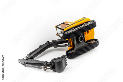 Overturned miniature excavator isolated on white background