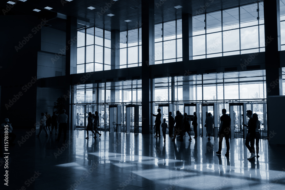 Silhouettes of people in modern lobby