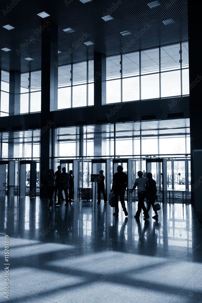 Silhouettes of people in modern lobby