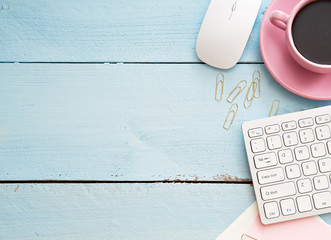 Office desk table with computer, supplies and coffee cup