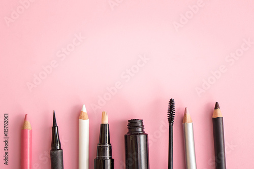 set of cosmetic products on pink background