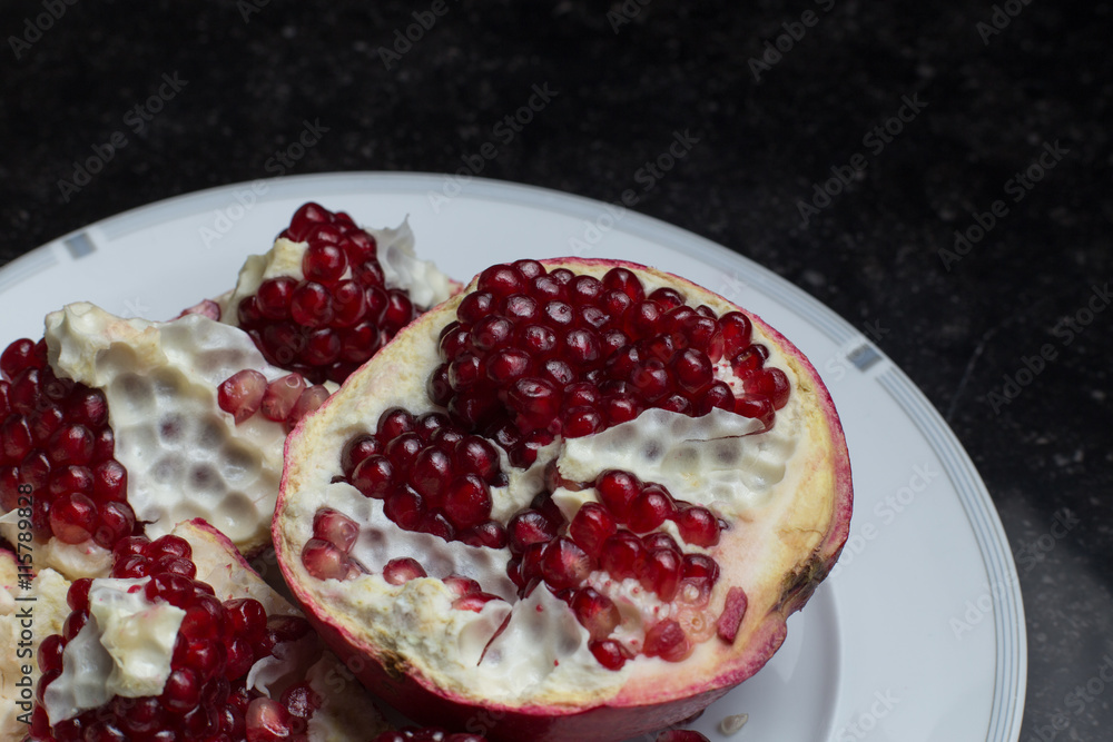 Red juicy pomegranate on dark marble background. Healthy, antioxidant, fresh, gourmet, delicious, organic fruit. Ingredient for grenadine. Close-up and copy space.
Red juicy pomegranate on dark marble background. Healthy, antioxidant, fresh, gourmet, delicious, organic fruit. Ingredient for grenadine. Close-up and copy space.