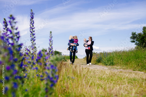 Family walking on field photo