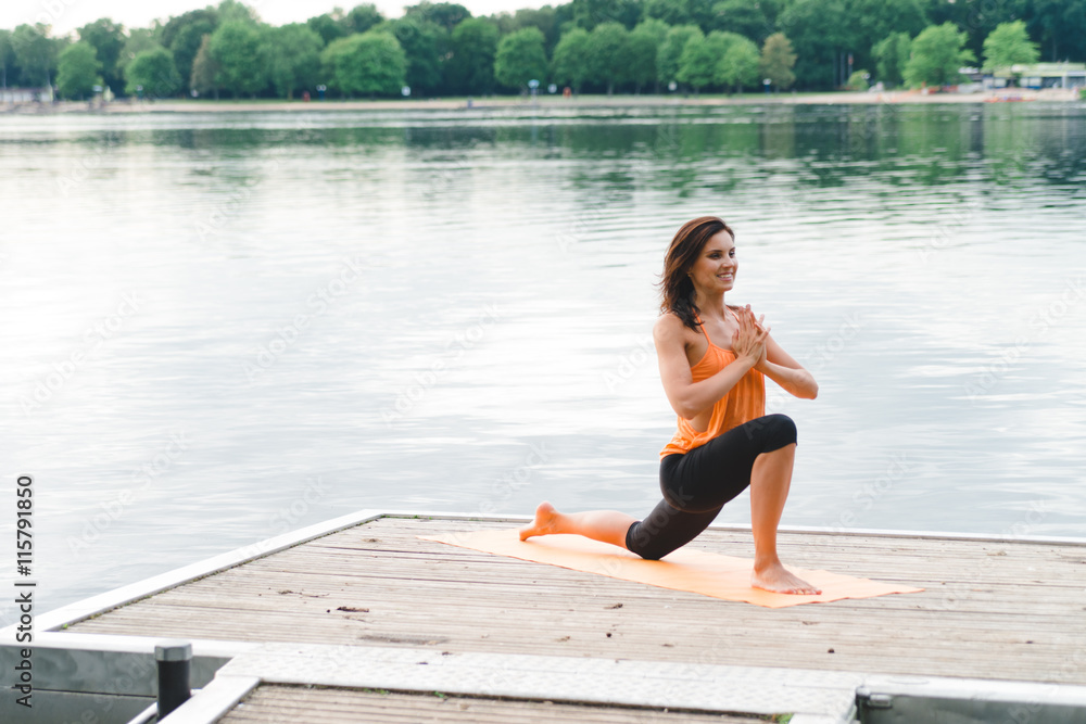 Young woman doing yoga on the lake Young woman doing yoga on the lake