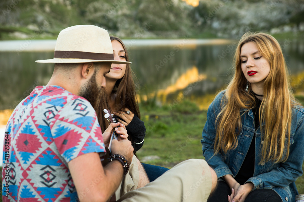Fototapeta premium Friends playing music and singing in a lake