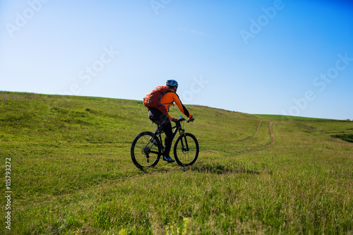 Cyclist on the Beautiful Meadow Trail © Aleksey