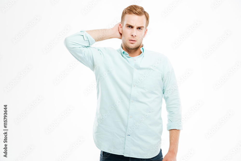 Pensive young man thinking and scratching his head Pensive young man thinking and scratching his head