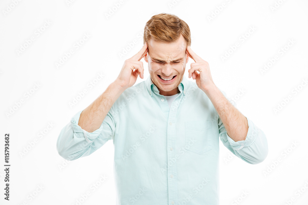 Fototapeta premium Stressful depressed man touching temples and having headache