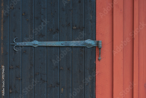Ornamented hinge on a black...
