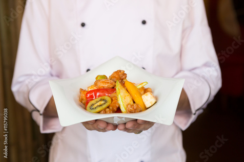 Cook holding plate with food