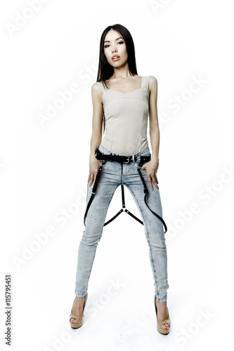 Young attractive woman wearing jeans with leather belt on white background