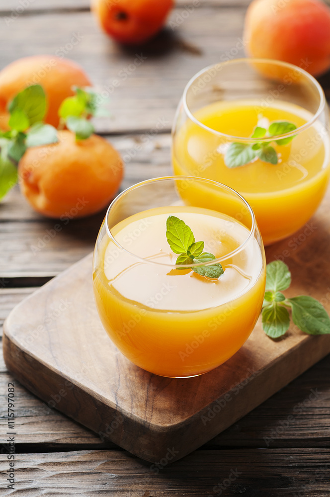 Healthy apricot juice with mint on the wooden table Healthy apricot juice with mint on the wooden table