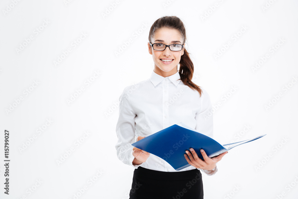 Happy young business woman in glasses standing and holding folder