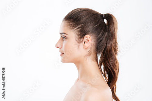 Profile of attractive young woman with ponytail photo