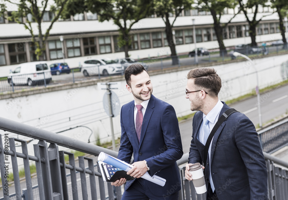 Two young businessmen walking together in the city Two young businessmen walking together in the city