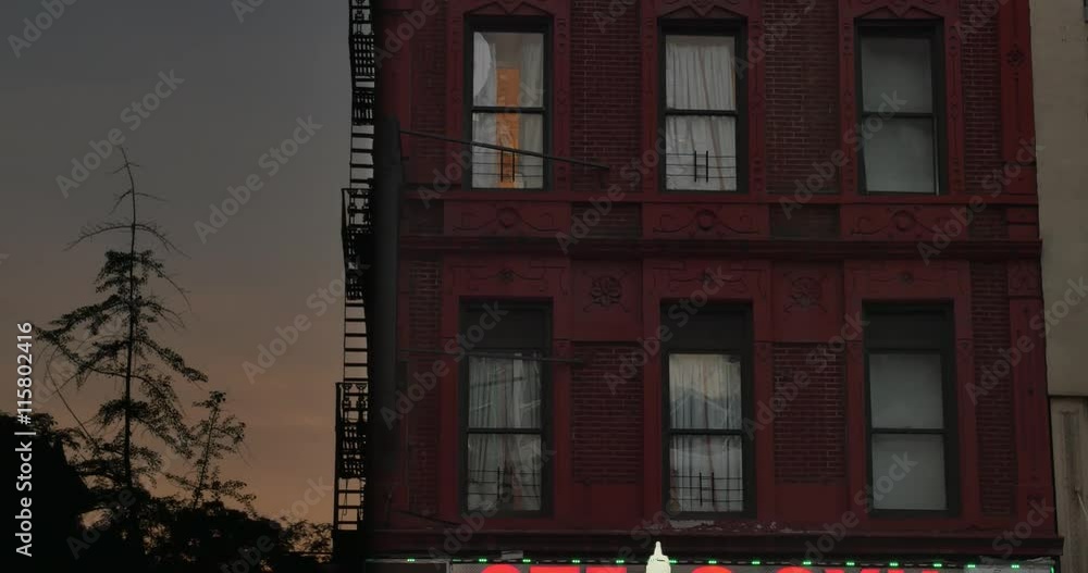A typical Manhattan apartment above a business at dusk. A typical Manhattan apartment above a business at dusk.