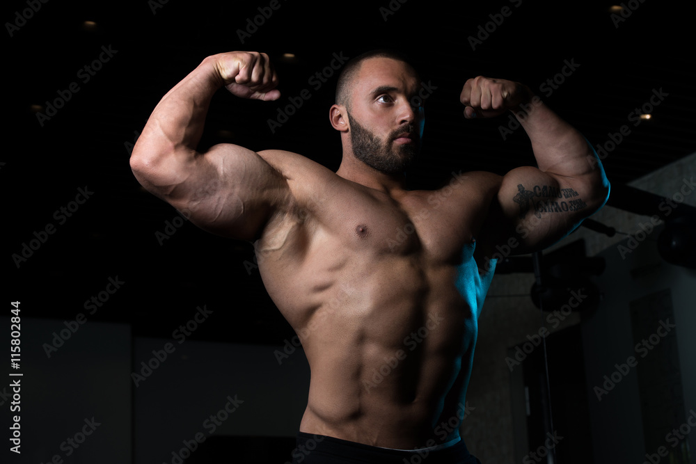 Bodybuilder Man Posing In The Gym
