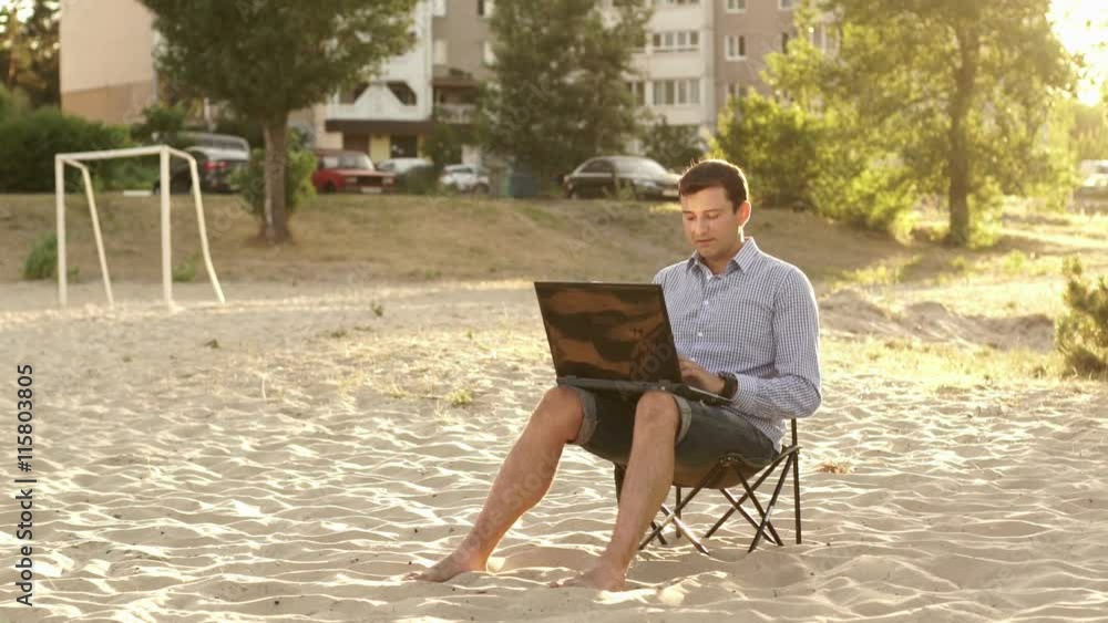 Young Business Man Working Remotely on Beach Young Business Man Working Remotely on Beach