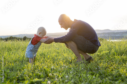 father and baby at sunset