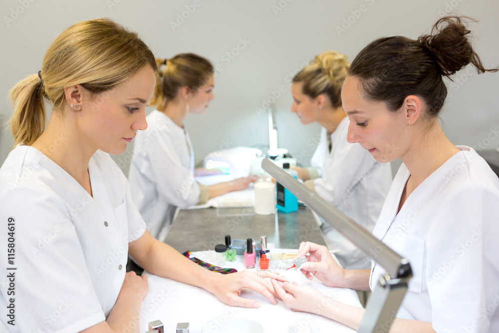 Young attractive beautician students practising during courses