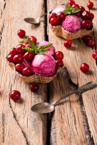 Fototapeta Naklejka Na Ścianę i Meble -  Sour cherry sundae with fresh fruits on wooden background. Sweet and summer concept