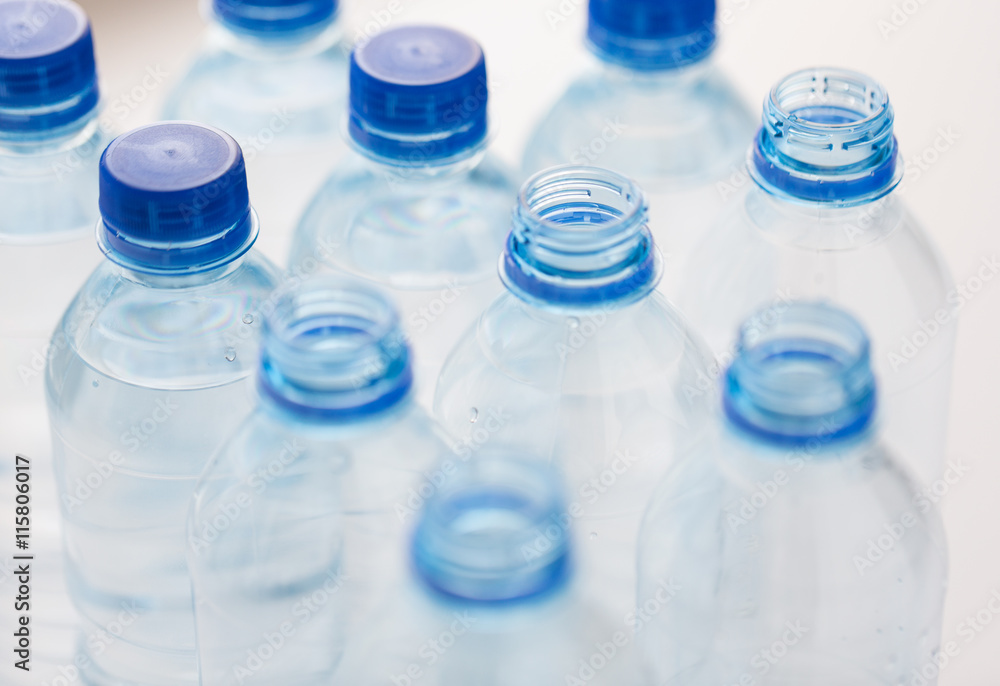 close up of bottles with drinking water on table close up of bottles with drinking water on table