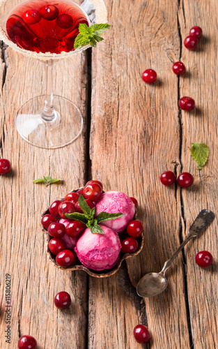 Sour cherry sundae with fresh fruits on wooden background. Sweet and summer concept