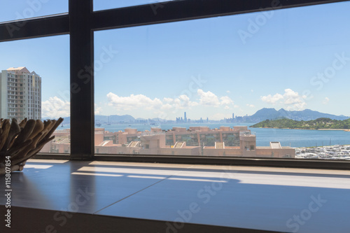 View from a window across Discovery Bay to HK Central's skyline in the distance