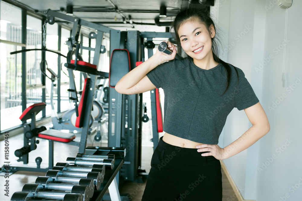 Portrait of pretty asian girl training in gym lifting barbell Portrait of pretty asian girl training in gym lifting barbell