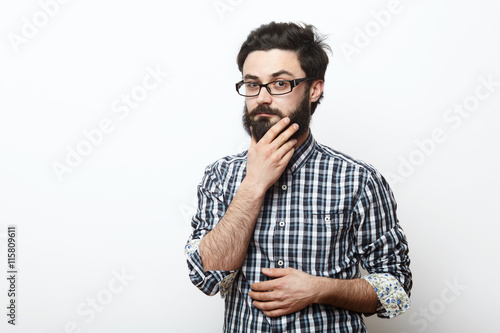 Принти на полотні man in glasses touching his beard and thinking