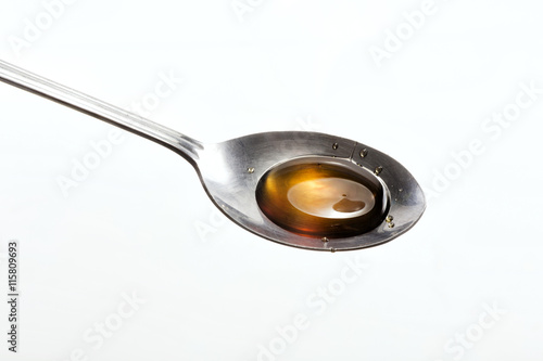 Honey drops on a spoon