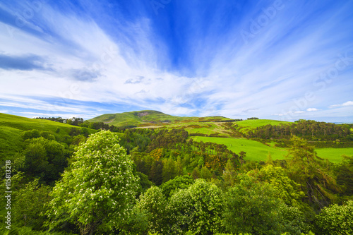 Landscape scenery of green valley, hill and cloudy blue sky