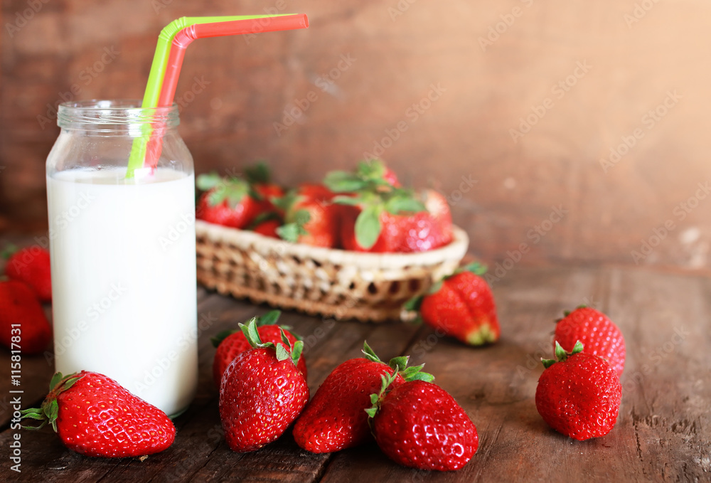 wooden table with strawberries and milk in a glass wooden table with strawberries and milk in a glass