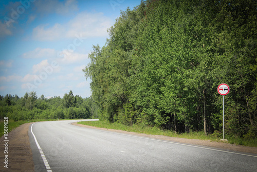 Desert road and forest along it