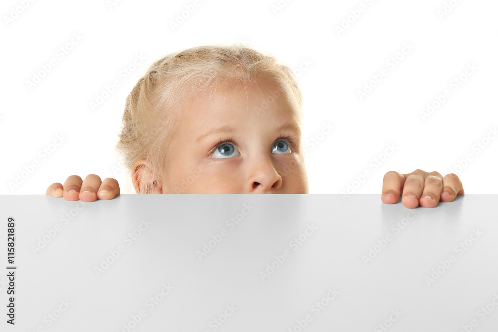 Funny little girl hiding behind white table Funny little girl hiding behind white table