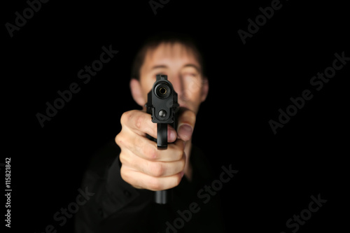 Man with gun on black background