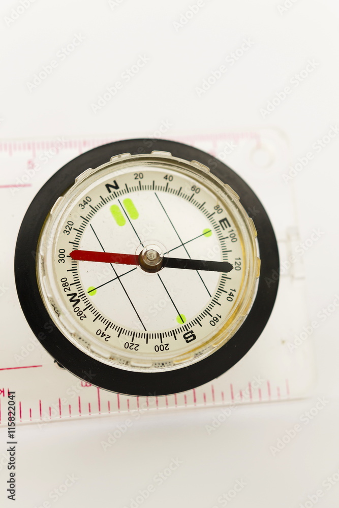 Detail shot of a glass compass on white background Detail shot of a glass compass on white background