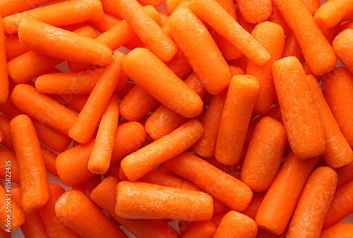 Fresh small baby carrots background