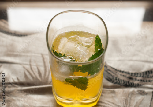 yellow drink with ice and mint,