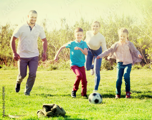 ﻿Family playing in football
