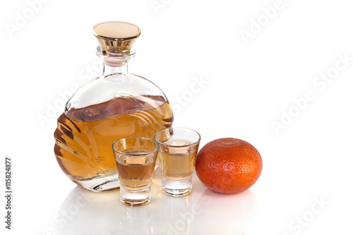 Bottle with glasses tequila and tangerine on white background