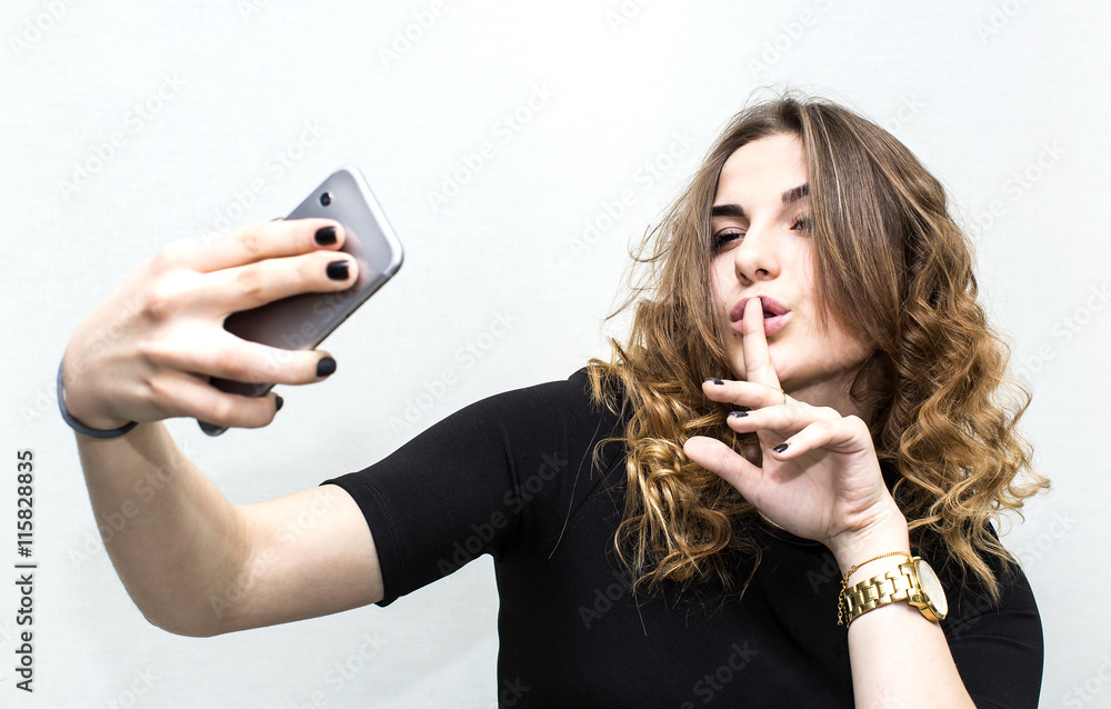 Girl doing self phone on a white background Girl doing self phone on a white background