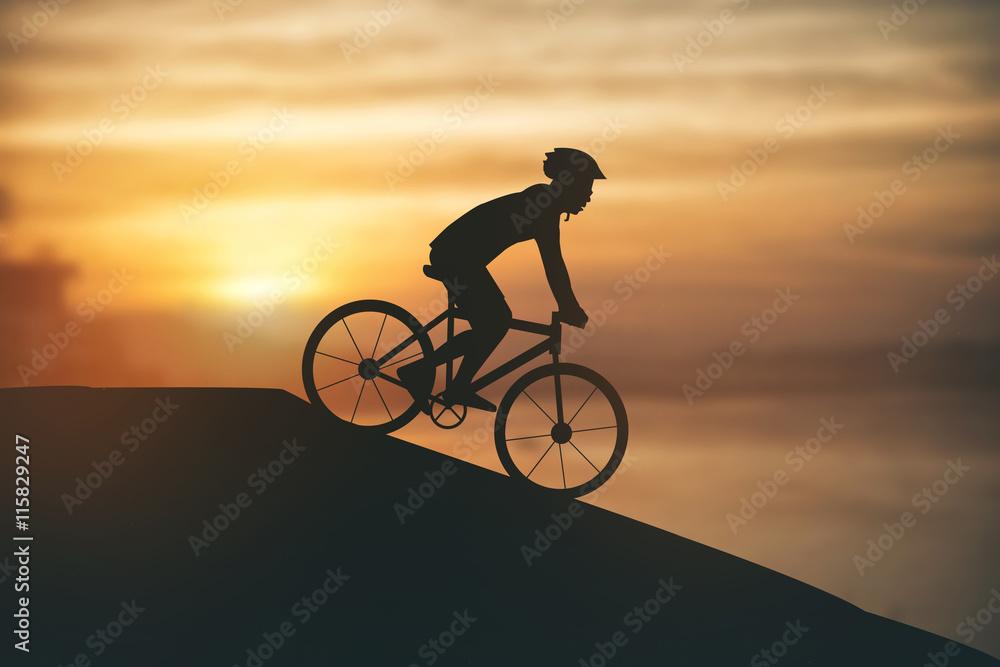 Fototapeta premium Silhouette of a man on muontain-bike, sunset
