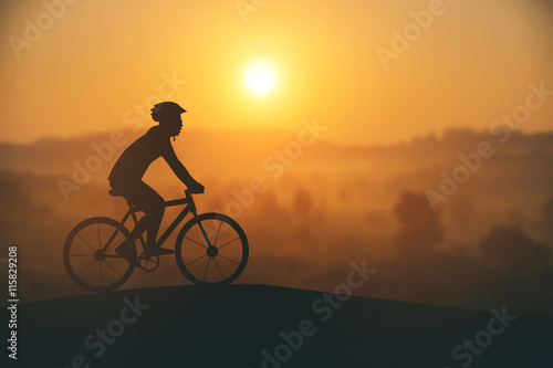 Silhouette of a man on muontain-bike, sunset